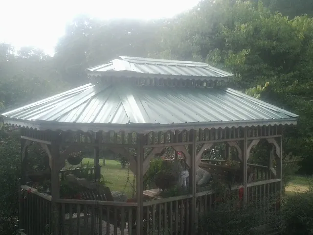 Two tier green metal roof on a garden gazebo in East Islip