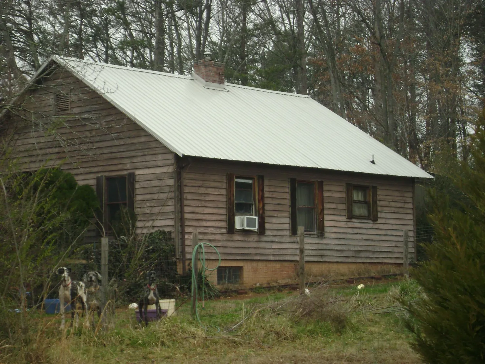 White metal roof on an old wood sided farmhouse, from a Metal Roof Installation job in East Islip